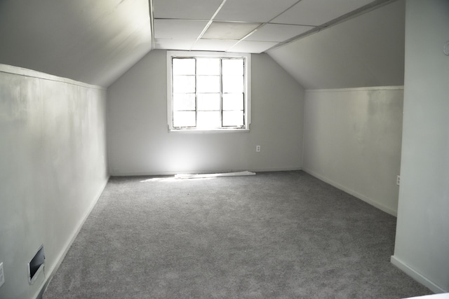 bonus room with carpet flooring and vaulted ceiling