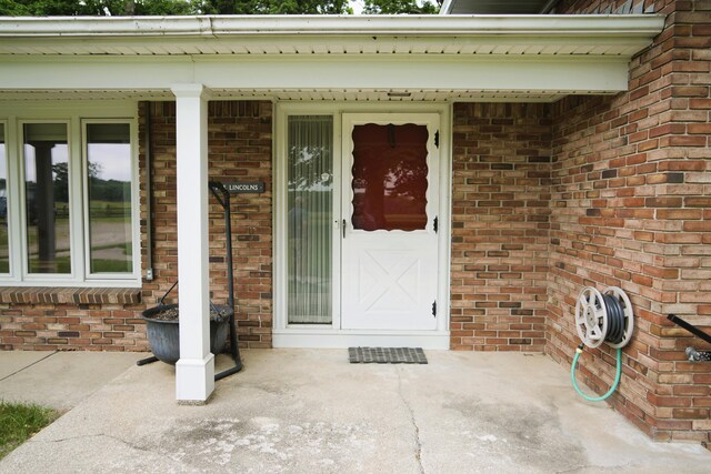 3447 200th Ave, Reed City, MI 49677 - doorway to property with brick siding