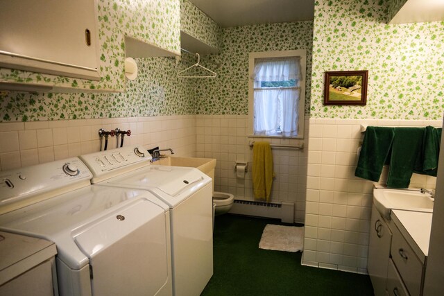 3447 200th Ave, Reed City, MI 49677 - laundry area featuring wallpapered walls, a baseboard heating unit, independent washer and dryer, a wainscoted wall, and tile walls