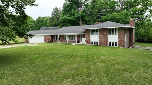 3447 200th Ave, Reed City, MI 49677 - split level home with a chimney, a garage, a front yard, concrete driveway, and roof with shingles