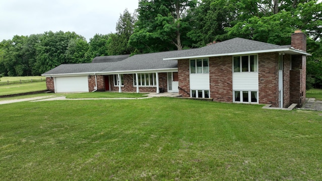 tri-level home with a garage and a front lawn