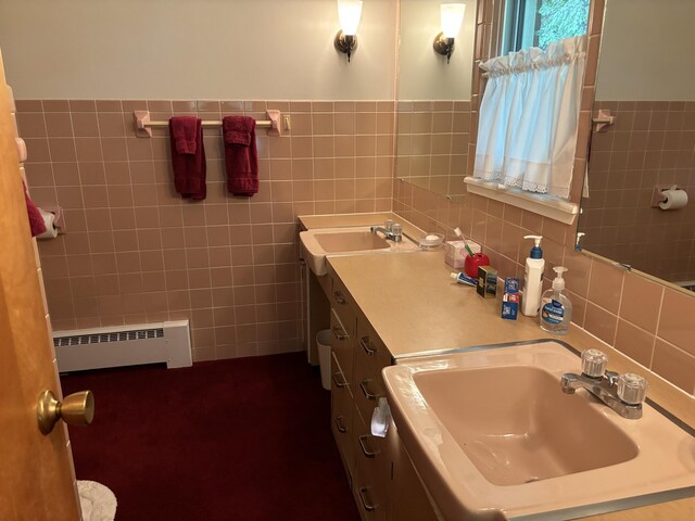 3447 200th Ave, Reed City, MI 49677 - full bathroom with tile walls, a baseboard radiator, and double vanity