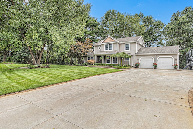 view of front of home with a garage and a front lawn