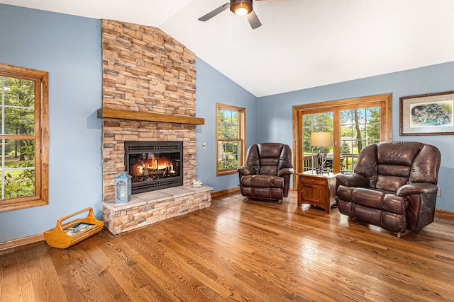 living room with hardwood / wood-style flooring, ceiling fan, a healthy amount of sunlight, and vaulted ceiling