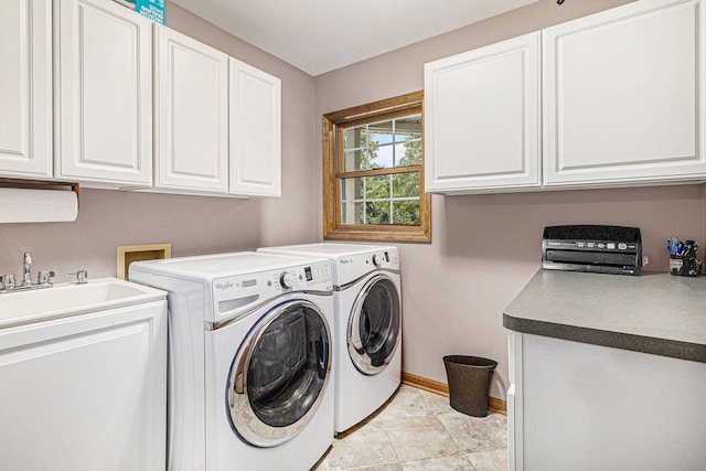 laundry area with separate washer and dryer, light tile patterned floors, and cabinets