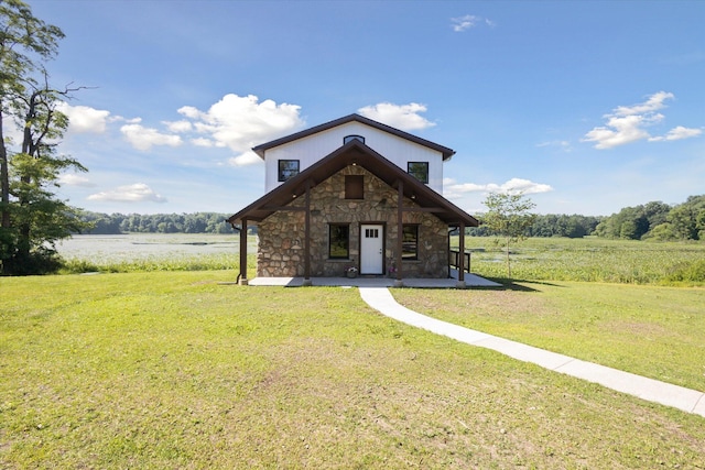 view of front of house with a front lawn and a rural view