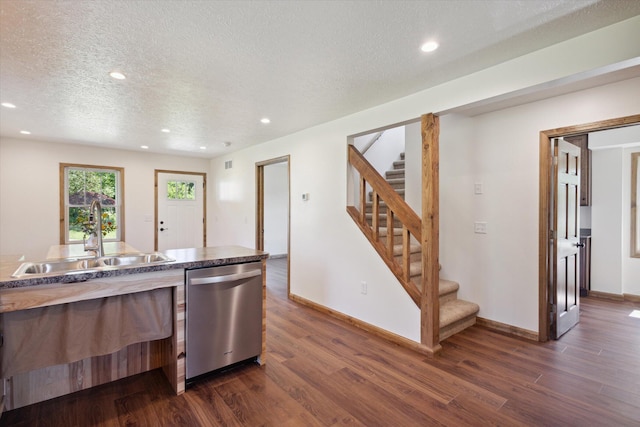 kitchen featuring a textured ceiling, dishwasher, dark hardwood / wood-style floors, and sink