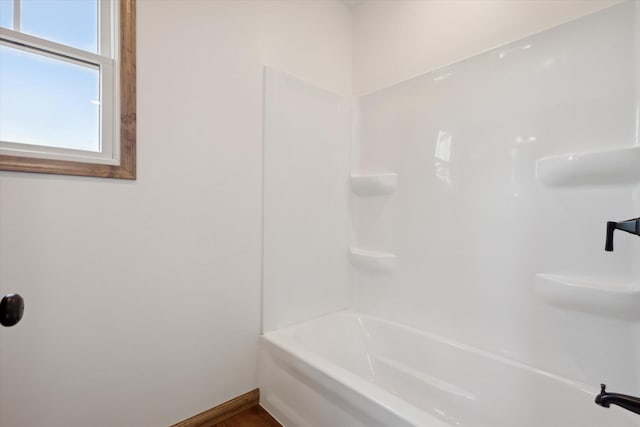 bathroom with shower / washtub combination