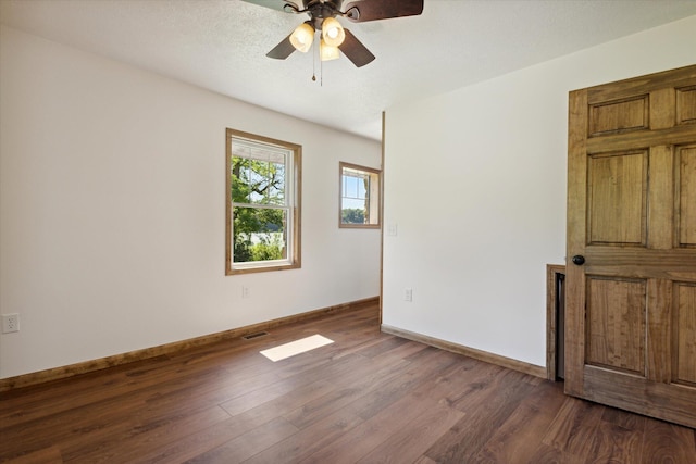 empty room with ceiling fan, a textured ceiling, and hardwood / wood-style flooring