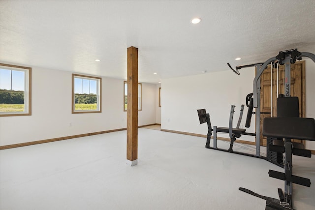 workout room featuring a textured ceiling