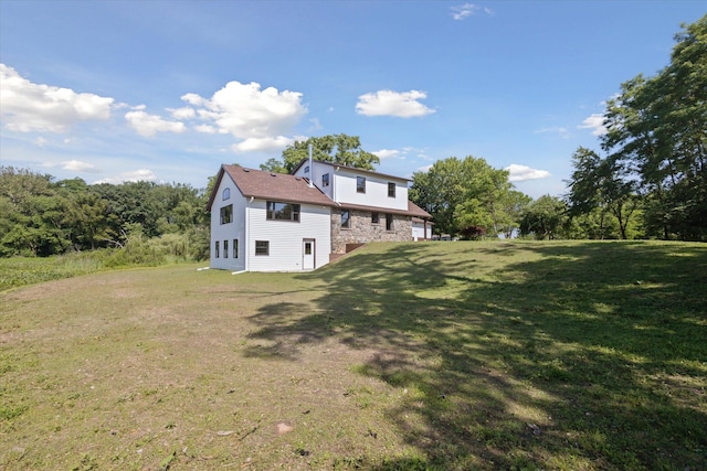 rear view of property with a lawn