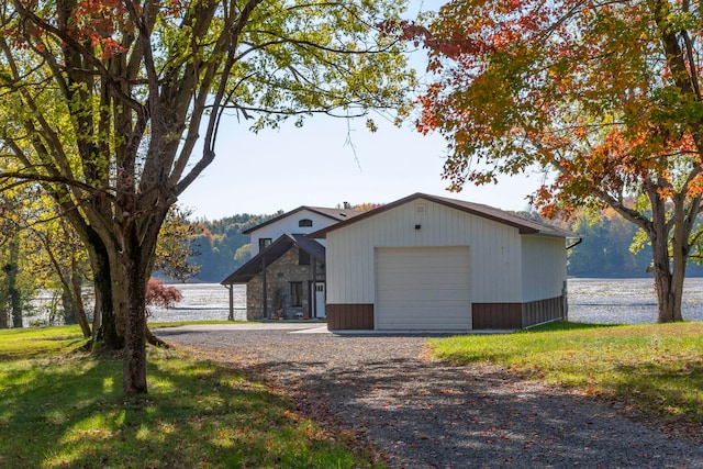 single story home featuring a garage and a water view