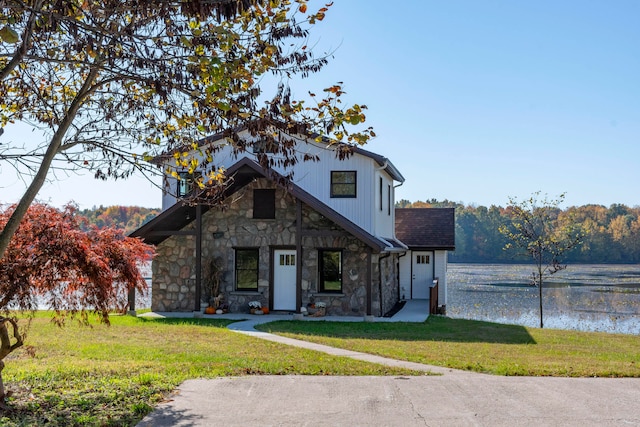 view of front facade with a water view and a front yard