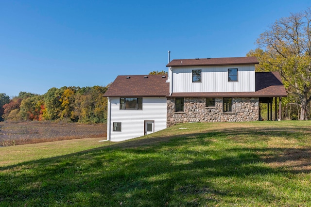 rear view of house with a yard