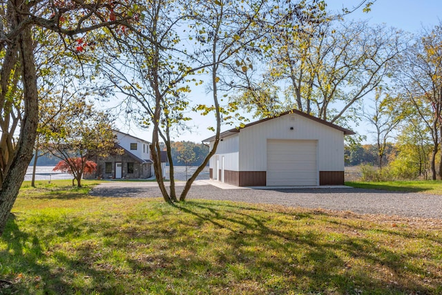 exterior space featuring a front lawn, an outdoor structure, and a garage