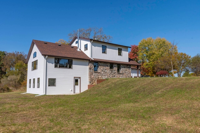 back of property featuring a yard