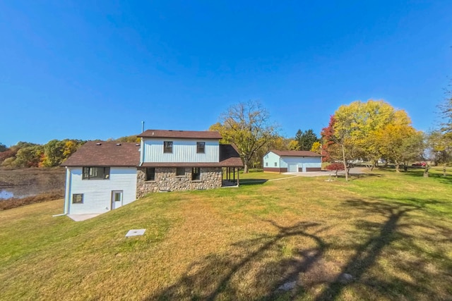 rear view of house featuring a yard