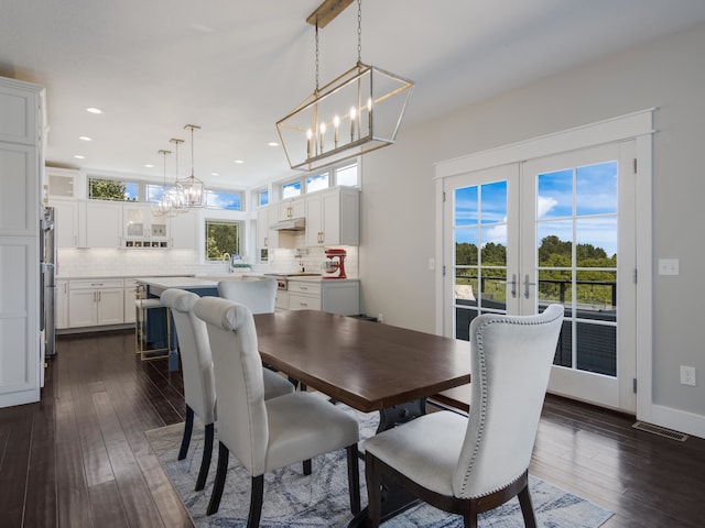 dining space featuring french doors and dark hardwood / wood-style floors