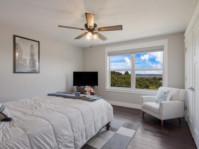 bedroom with ceiling fan and dark hardwood / wood-style floors