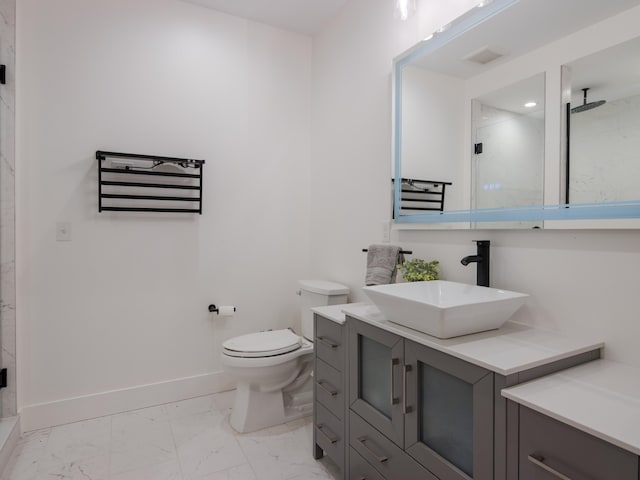 bathroom with walk in shower, vanity, and toilet