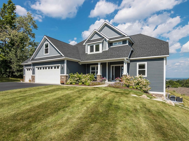 craftsman-style home featuring a porch, a garage, and a front lawn