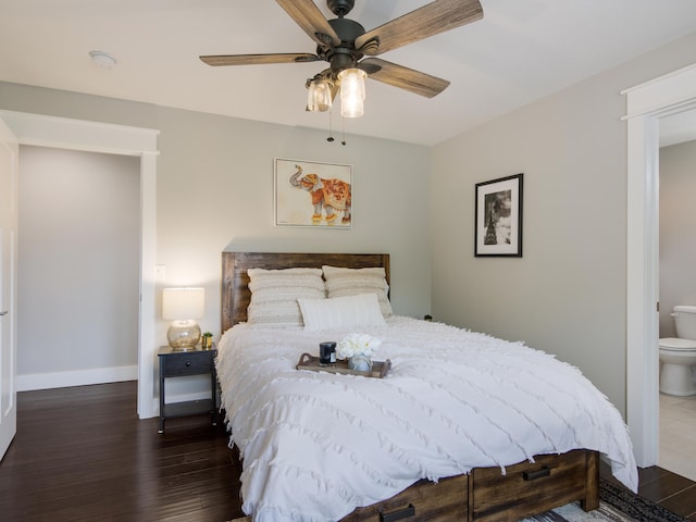 bedroom featuring ceiling fan, dark hardwood / wood-style flooring, and ensuite bath