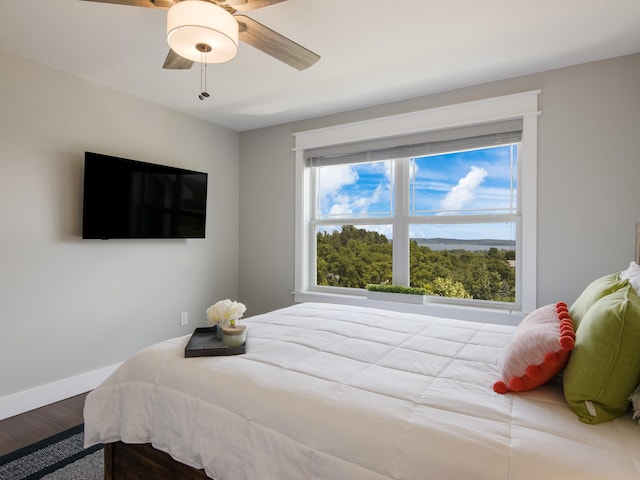 bedroom with wood-type flooring and ceiling fan