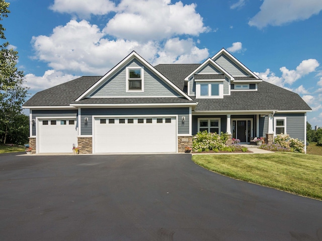 craftsman-style house with a garage and a front yard