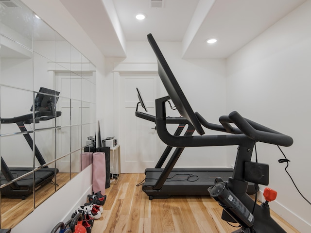 workout area with hardwood / wood-style flooring