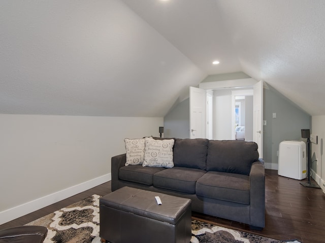 living room featuring dark hardwood / wood-style flooring and lofted ceiling