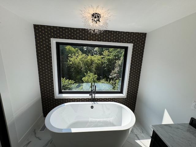 bathroom with plenty of natural light and a bath