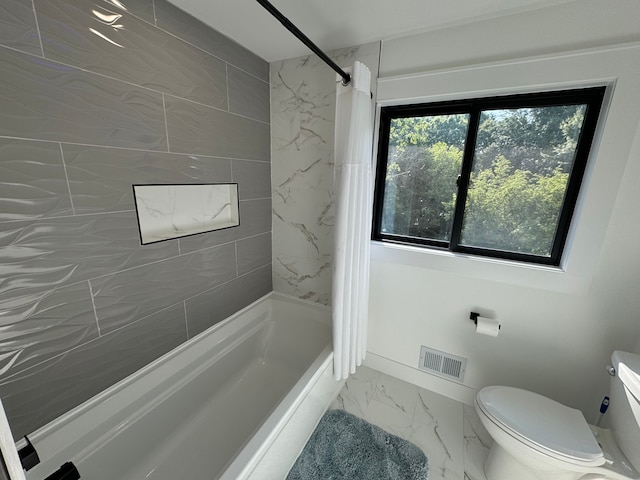 bathroom featuring toilet and shower / bath combination with curtain