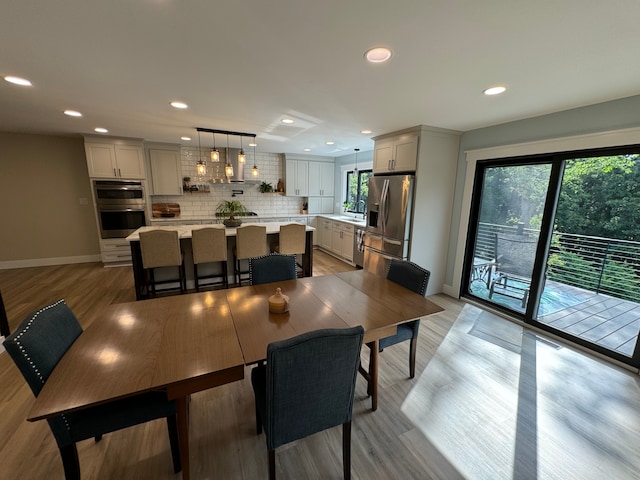 dining room with light wood-type flooring and sink