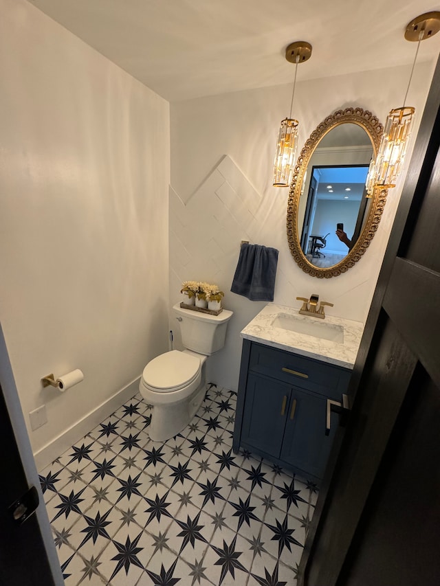 bathroom featuring toilet and vanity