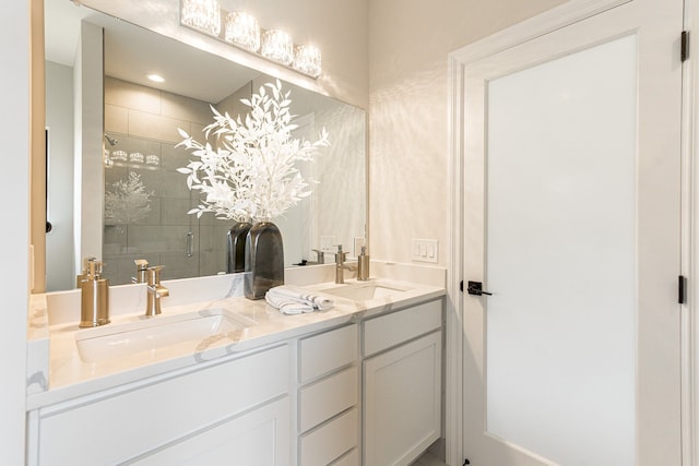 bathroom with vanity and a shower with shower door