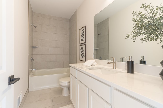 full bathroom featuring tile patterned floors, vanity, tiled shower / bath combo, and toilet