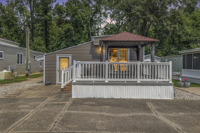 486 Maple Ln, Coldwater, MI 49036 - back of property featuring a gazebo, cooling unit, metal roof, and view of wooded area