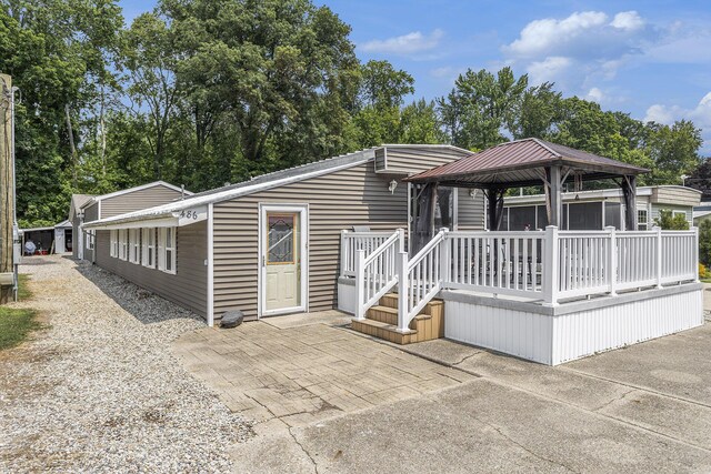 486 Maple Ln, Coldwater, MI 49036 - manufactured / mobile home featuring a gazebo, a patio area, metal roof, and a wooden deck