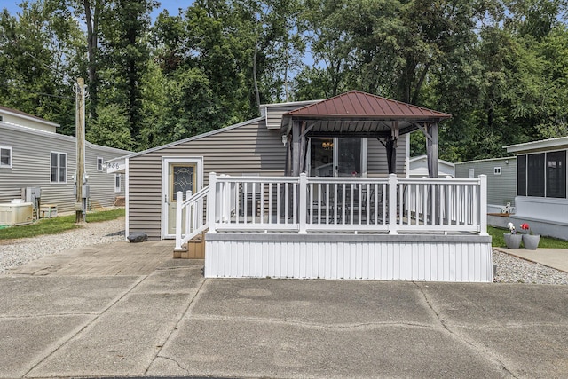 486 Maple Ln, Coldwater, MI 49036 - back of house with a gazebo, a deck, metal roof, and central AC