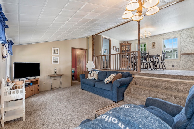 living room with a chandelier and carpet