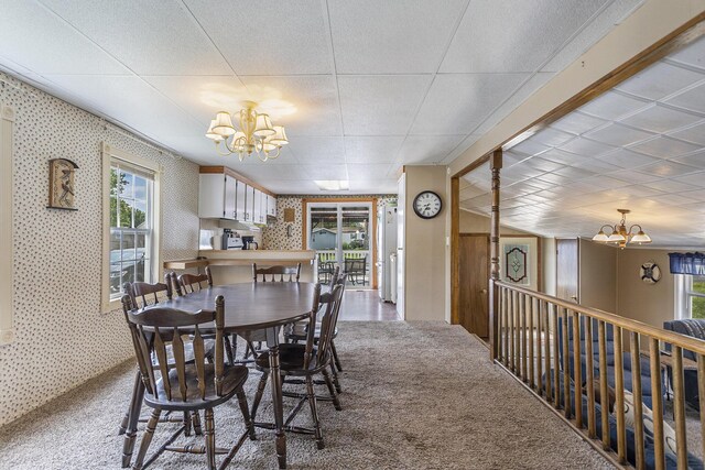 486 Maple Ln, Coldwater, MI 49036 - dining area featuring a chandelier, plenty of natural light, carpet floors, wallpapered walls, and a drop ceiling