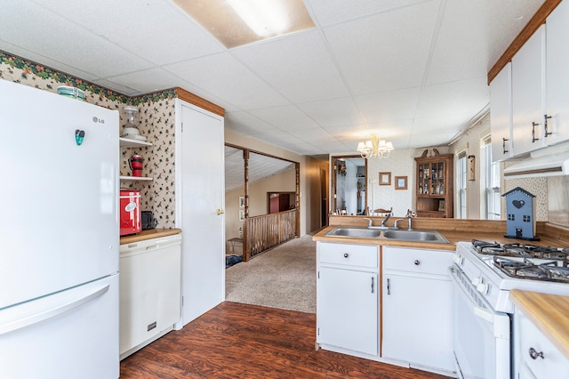 kitchen with white cabinets, dark hardwood / wood-style flooring, white appliances, and sink