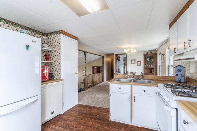 486 Maple Ln, Coldwater, MI 49036 - kitchen featuring white appliances, a sink, dark wood-style flooring, a chandelier, and white cabinetry