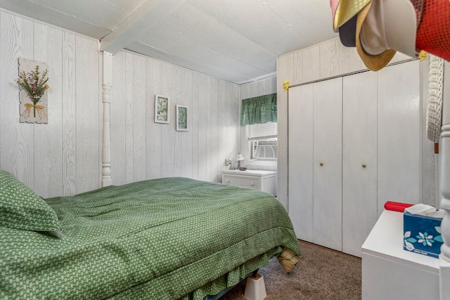 bedroom with carpet, wood walls, beam ceiling, and cooling unit