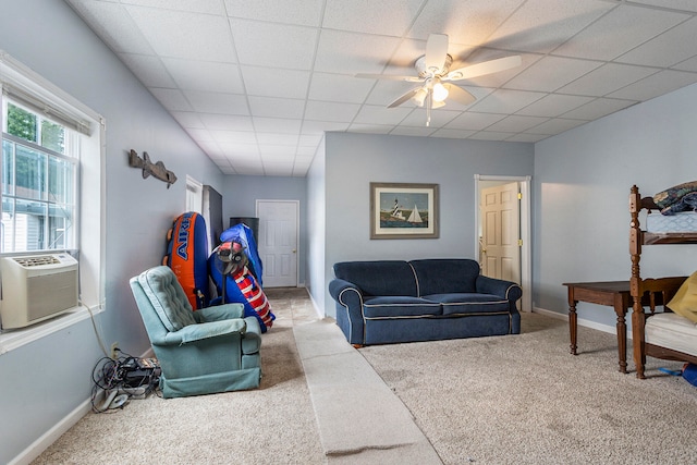 living room featuring carpet floors, cooling unit, ceiling fan, and a paneled ceiling