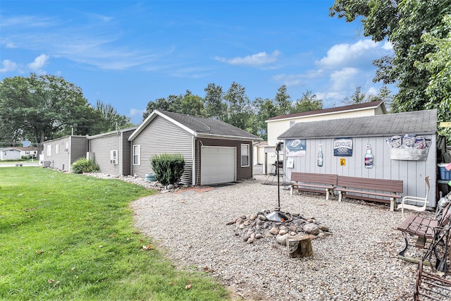 exterior space featuring a yard, an outdoor structure, and a garage