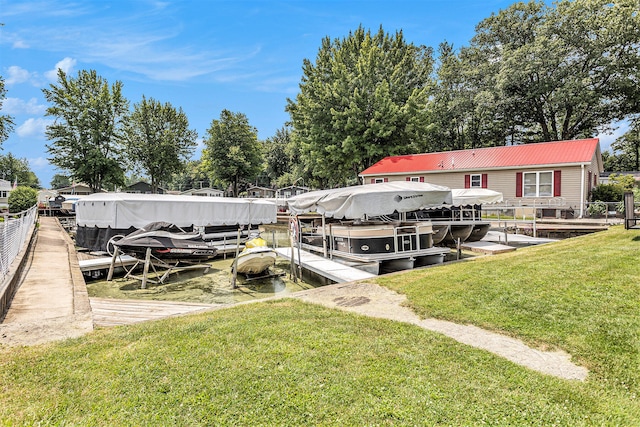 dock area with a yard and a water view