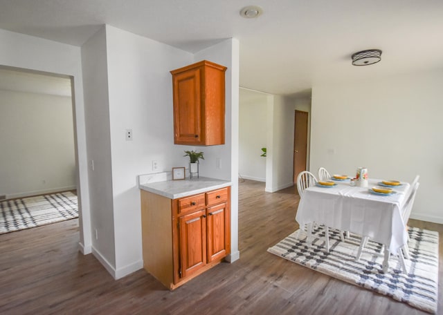 kitchen with dark hardwood / wood-style flooring