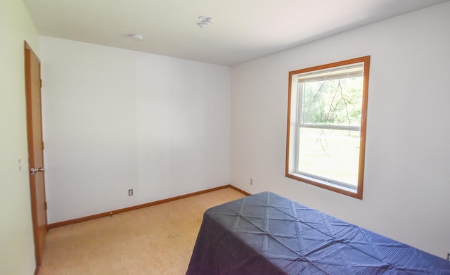 bedroom with light colored carpet