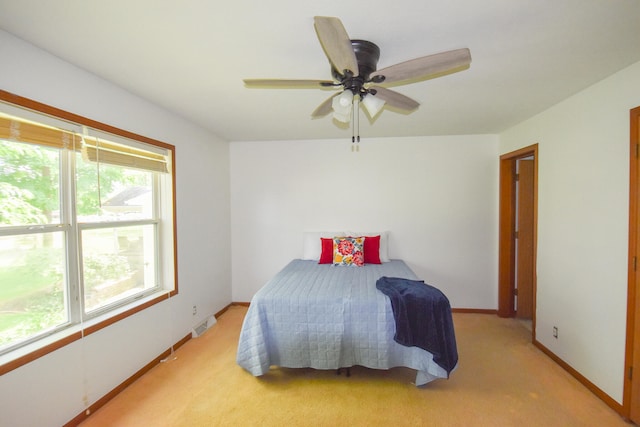 carpeted bedroom with ceiling fan